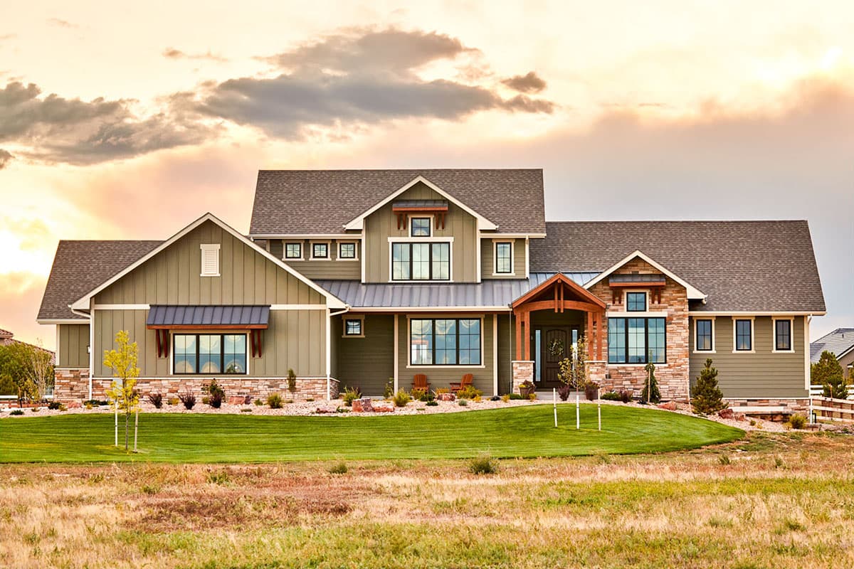 House plan exterior. Two-story Modern Farmhouse with gables, stone accents, and covered front porch. Features include board and batten siding.