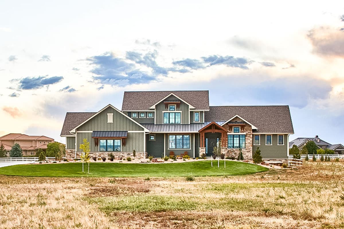 Modern Farmhouse style house plan exterior with two stories, gables, dormers, stone accents, and a covered entryway.