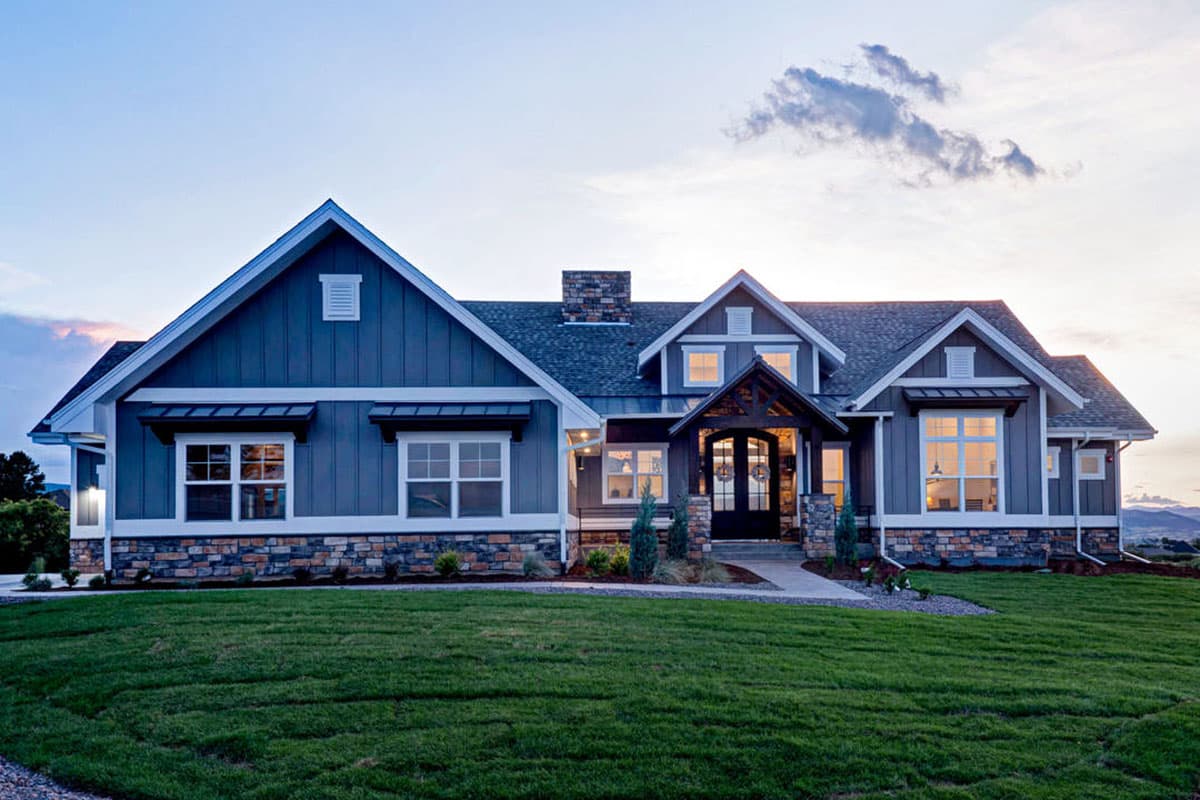 Modern Farmhouse house plan exterior with stone foundation, prominent gables, and covered entry.