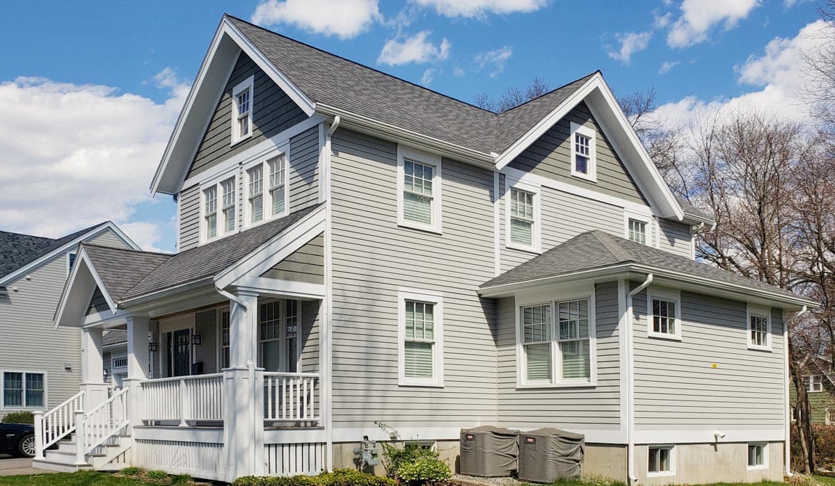 House plan exterior: two-story Modern Farmhouse with gabled dormers, front porch, and horizontal siding.