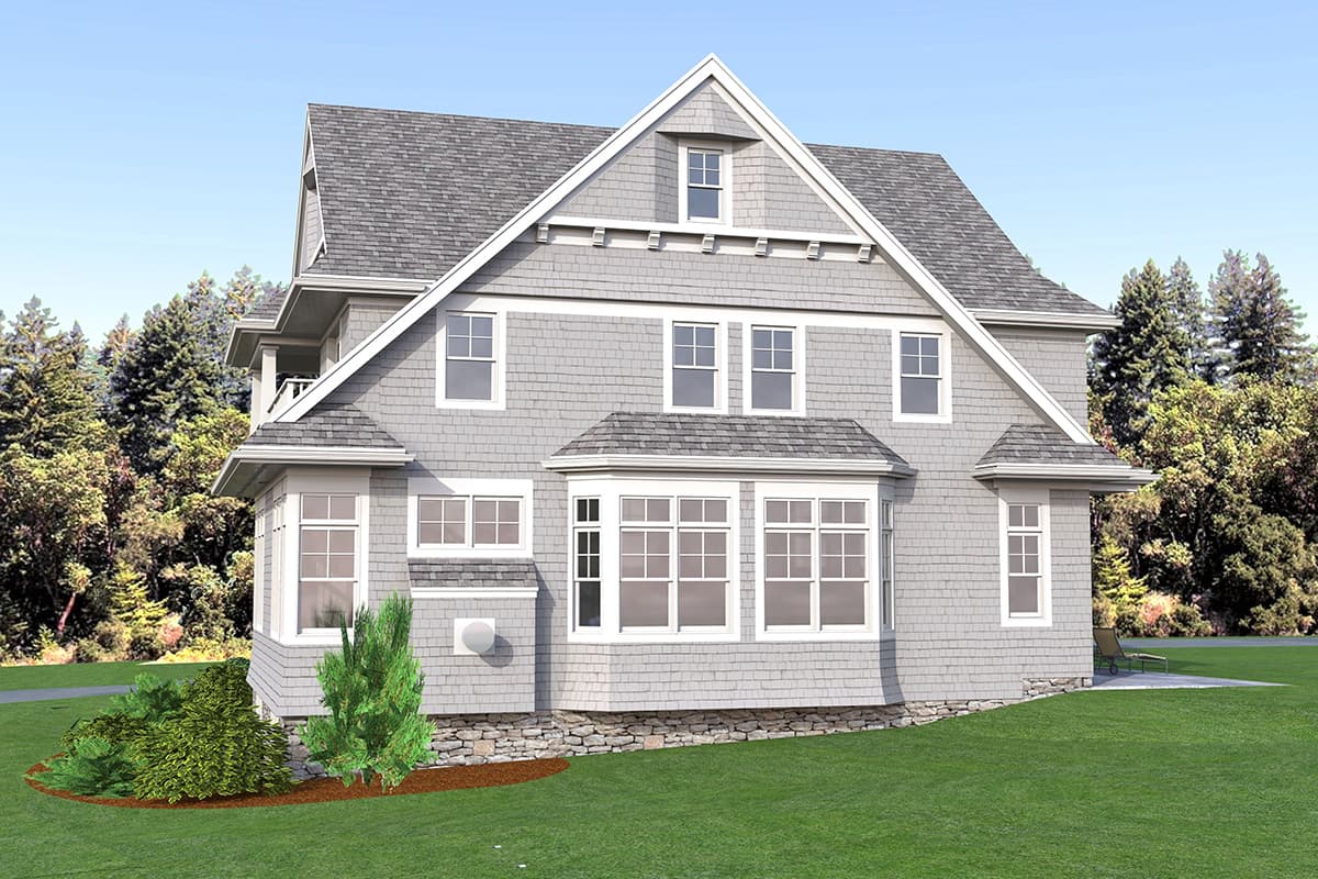 House plan exterior: three-story gray shingle home with a prominent gable, bay windows, dormers, and a second-story balcony.