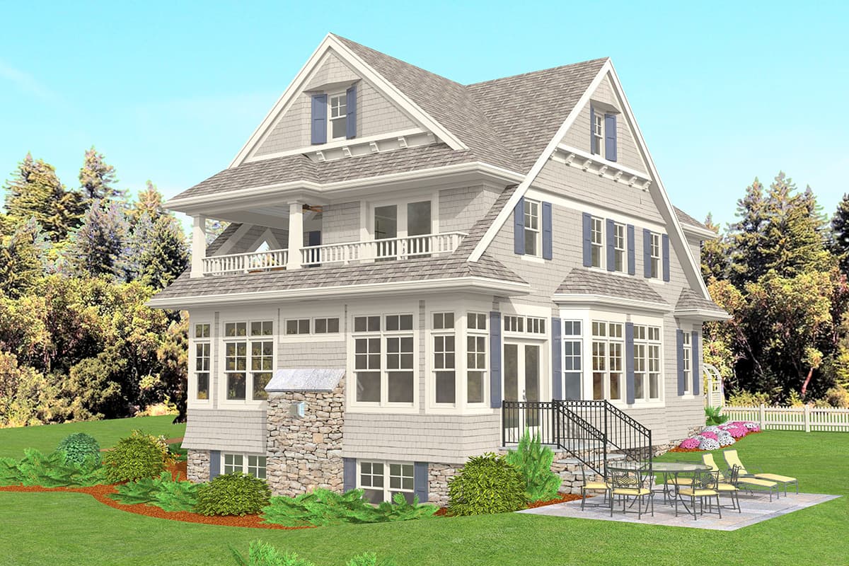 House plan exterior: Three-story home with gabled dormers, upper balcony, and stone foundation.