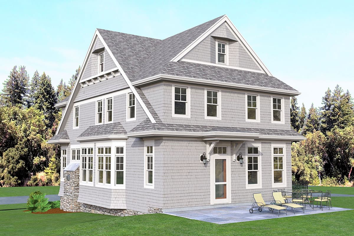 House plan exterior of a two-story home with a prominent gable, dormers, bay windows, and stone foundation.