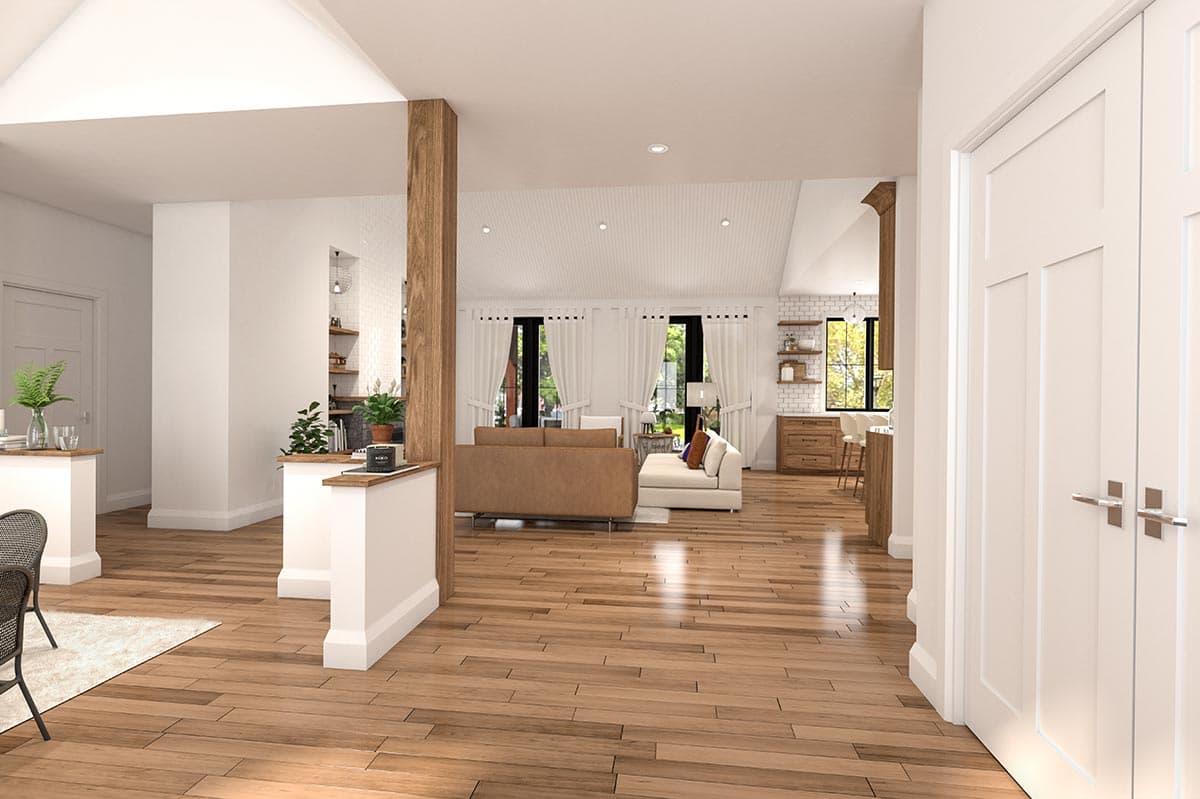 Interior rendering shows an open-concept living area with vaulted ceilings, wood beams, and a large kitchen island.