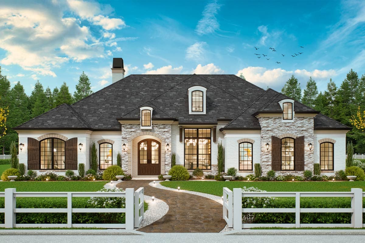 House plan exterior with stone accents, arched windows, and dormers. Features include a front entry with a curved walkway and a dark shingle roof.