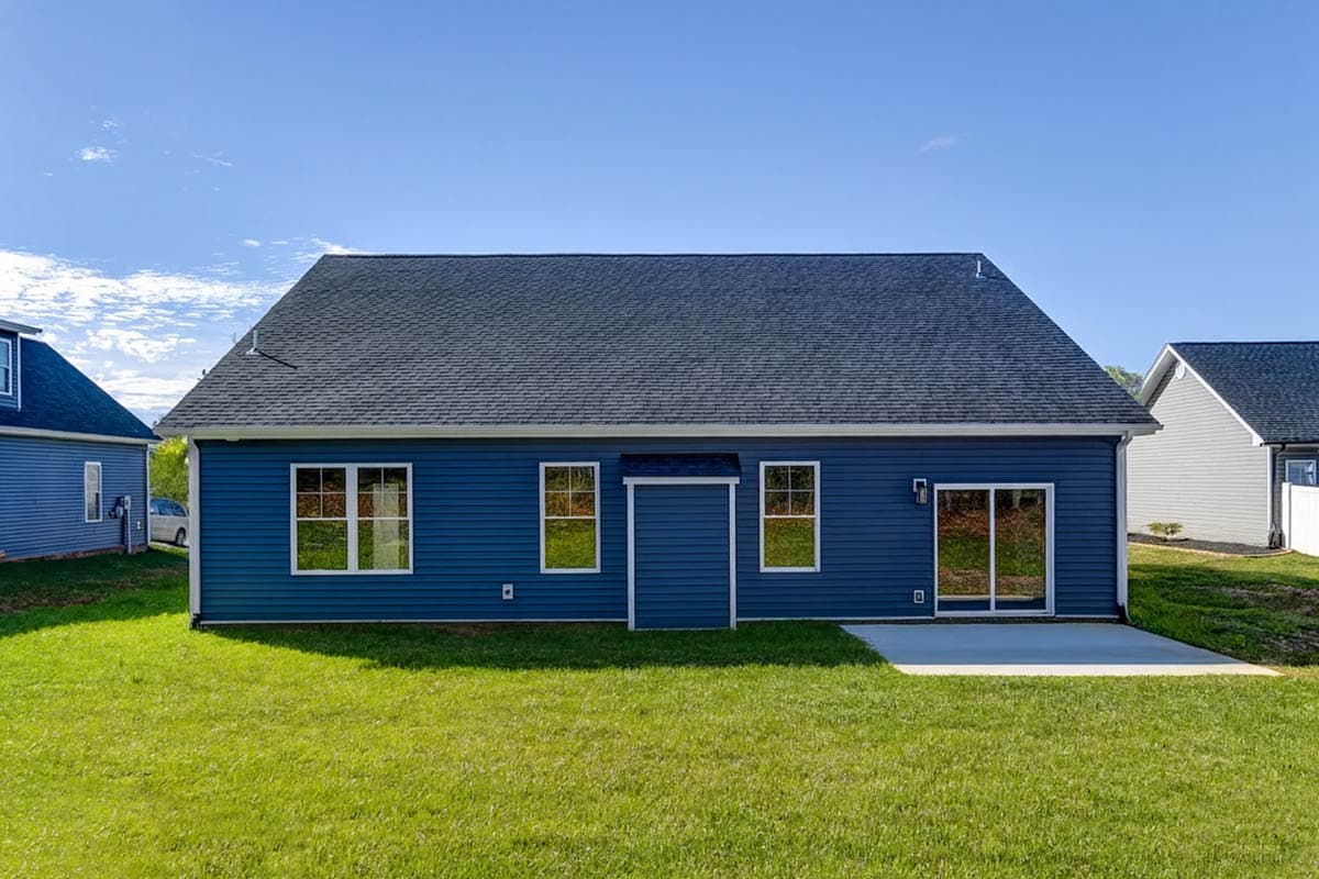 House plan exterior of a one-story blue home with gabled roof, three windows, a central door, and a sliding glass door leading to a patio.