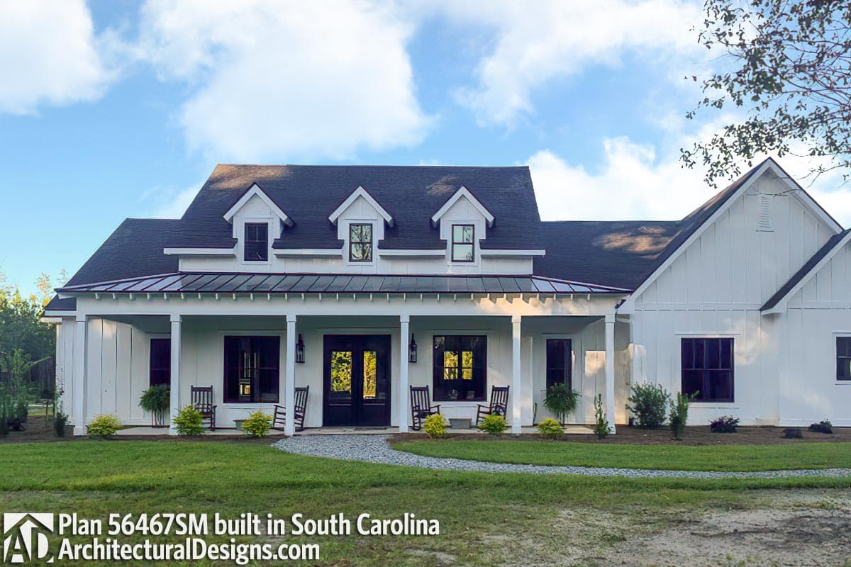 Modern Farmhouse house plan exterior with a covered porch, metal roof overhang, and multiple dormers.