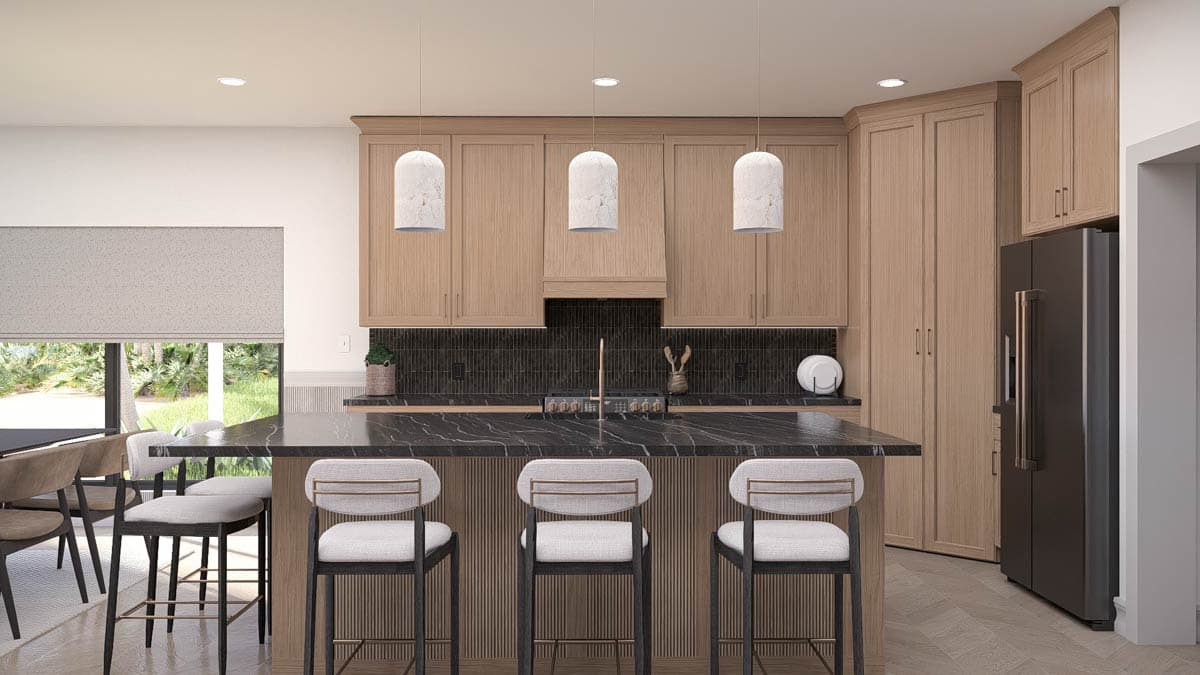 Modern kitchen with a black marble island, three bar stools, and three pendant lights above. Light wooden cabinetry and a dark refrigerator.