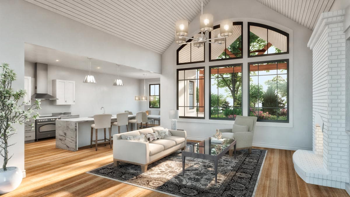 Open concept living area with vaulted wood-paneled ceiling, large arched windows, kitchen island, and brick fireplace.