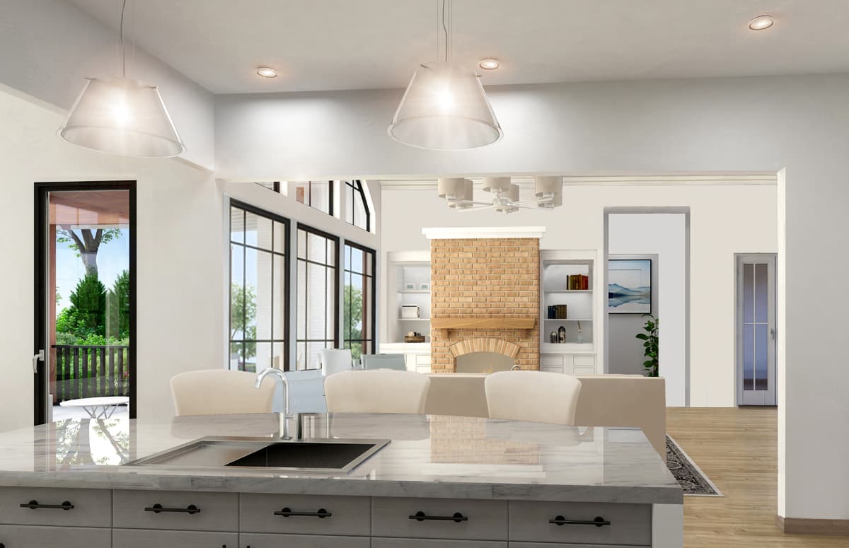 Kitchen island with sink faces open great room with brick fireplace, vaulted ceiling and large windows.