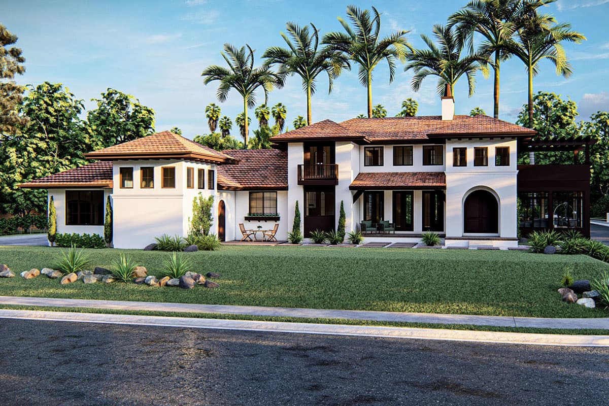 House plan exterior view of a two-story home in a Mediterranean style. Features include a tile roof, an arched entry, and a covered porch.