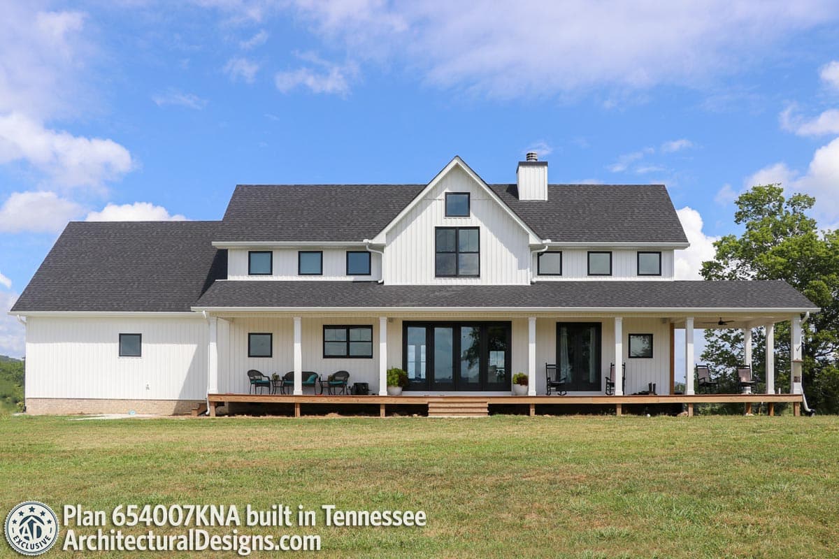 Modern Farmhouse house plan exterior with a wrap-around porch, board-and-batten siding, gables, and a prominent central dormer.