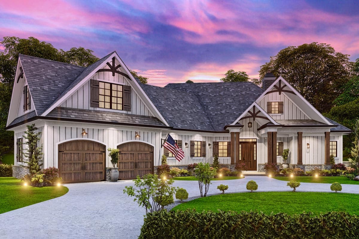 House plan exterior. A two-story farmhouse with gables, a covered entry, and a two-car garage with arched doors. Features include decorative shutters.