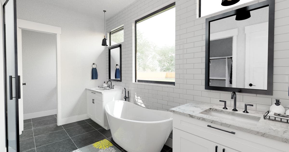 Modern bathroom with freestanding tub, dual vanities, subway tile, and large windows.