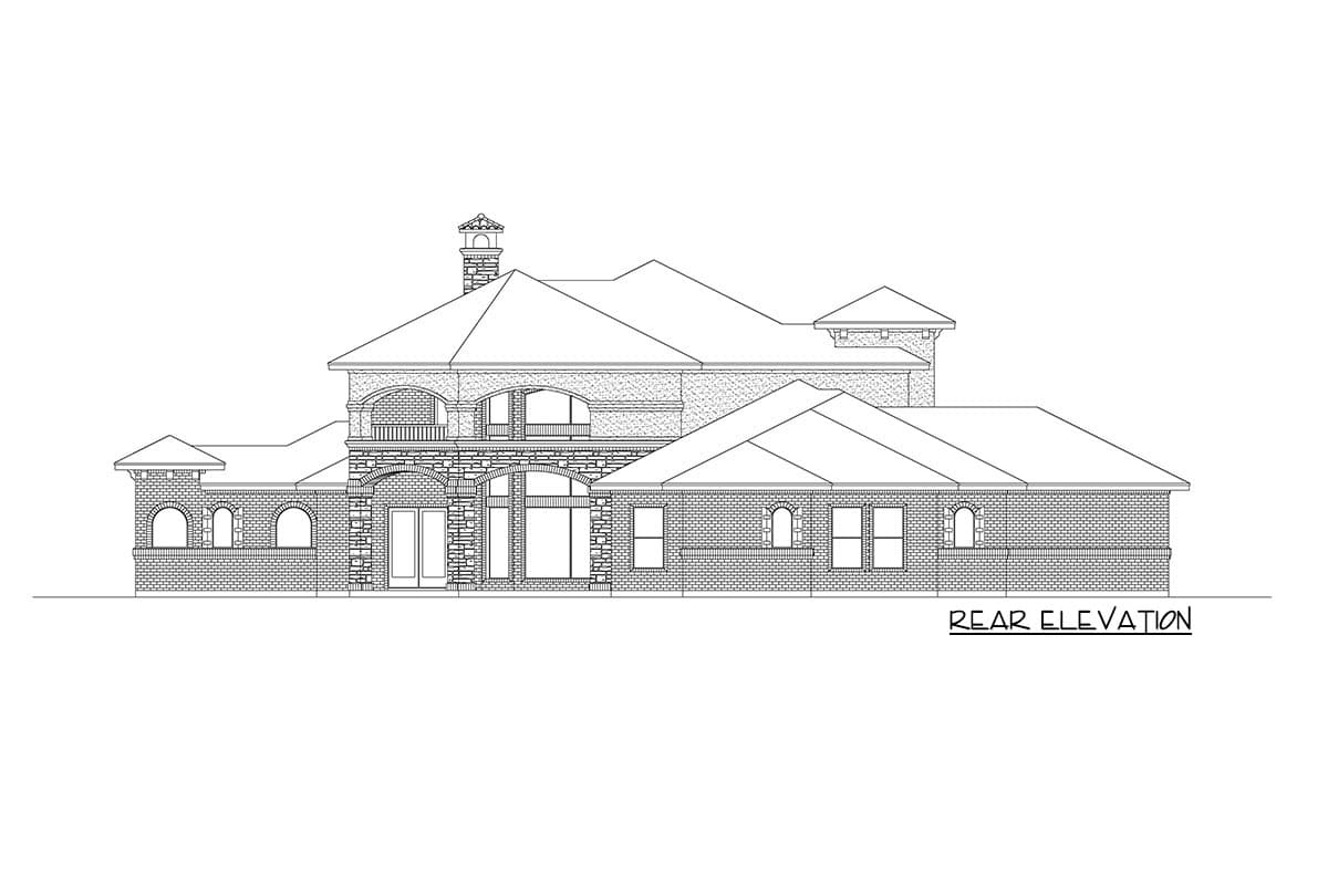 Rear elevation drawing of a house plan featuring multiple gables, arched windows, a balcony, and stone accents.