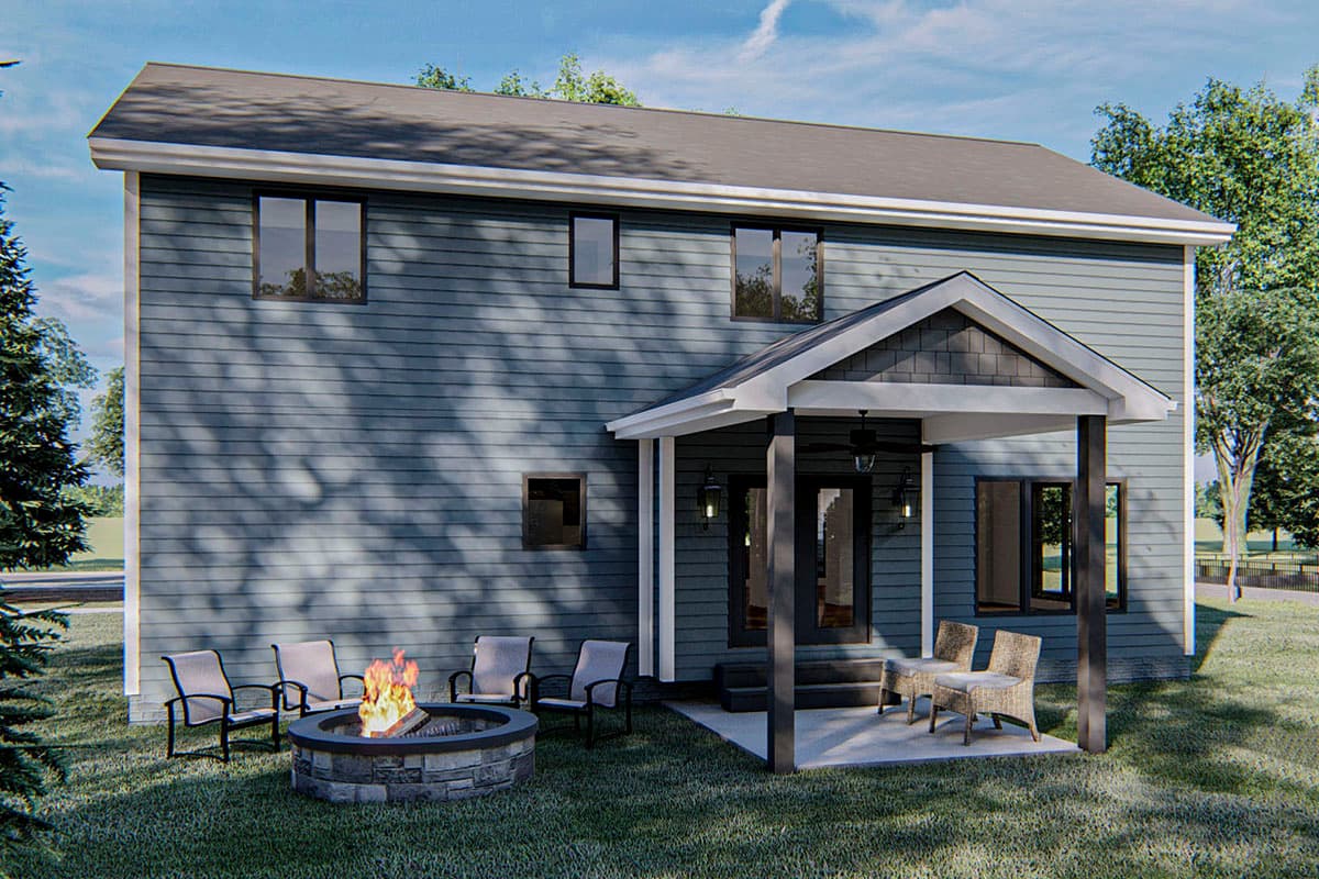 House plan exterior: Two-story blue siding home with covered porch, gabled roofline, and outdoor seating area with fire pit.