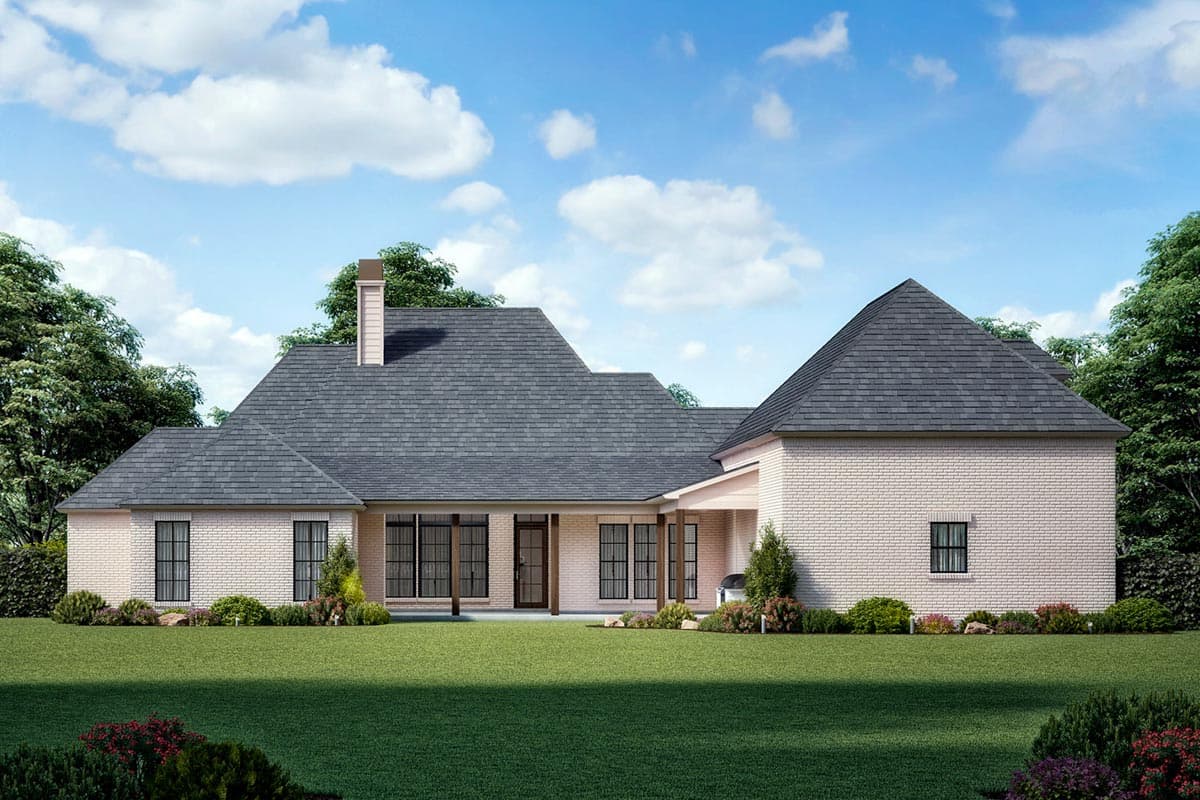 House plan exterior: Ranch-style, single-story brick home with multiple gables, a covered porch, and a prominent chimney.