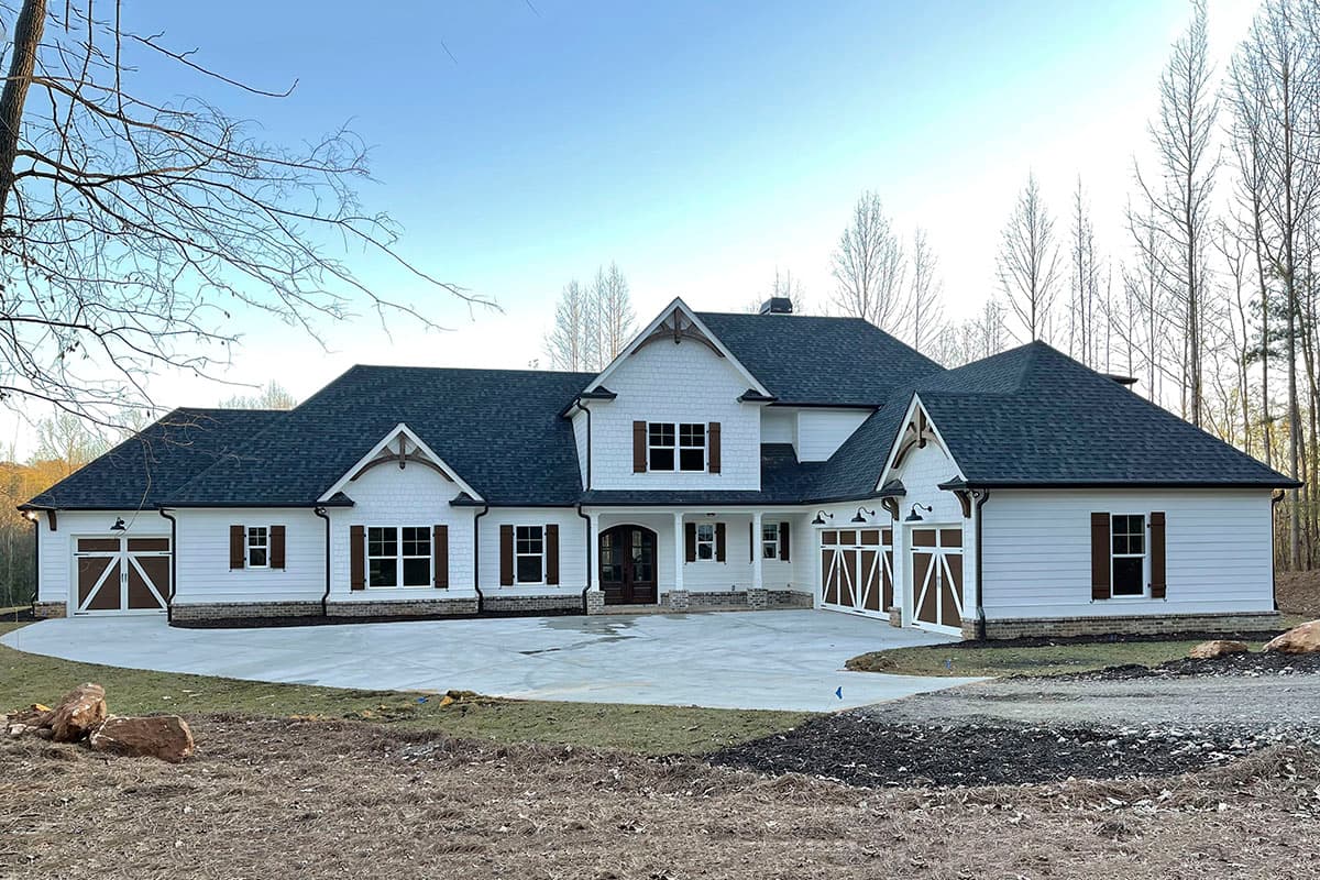 Modern Farmhouse house plan exterior with multiple gables, a covered entry, and a three-car side-entry garage.