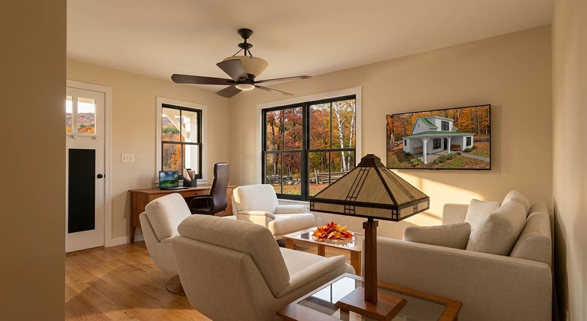 Living room rendering with sofa, chairs, desk, and a framed picture of a house exterior.