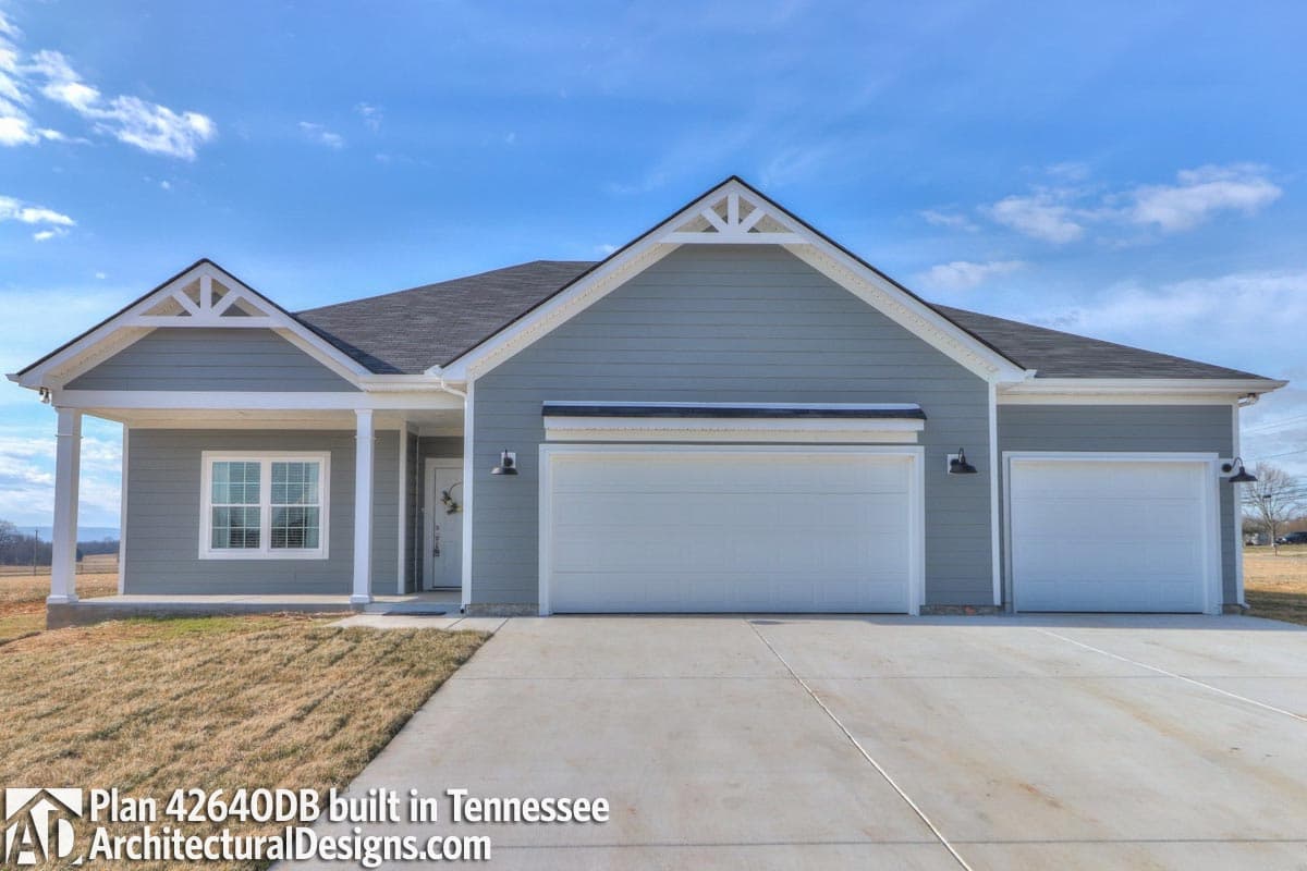 Ranch house plan exterior with a covered front porch, gable accents, and a three-car front-facing garage.