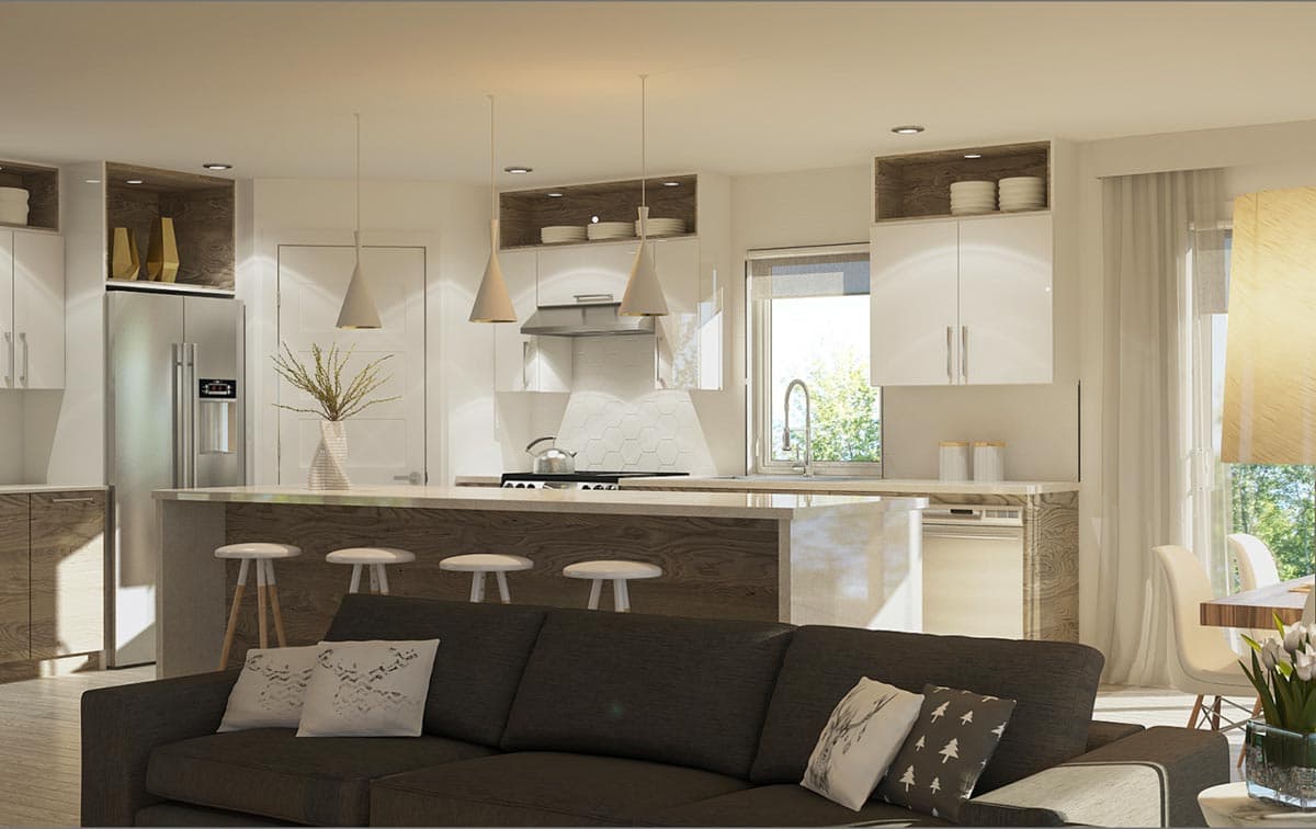 Open-plan kitchen and living area featuring a large island with seating, stainless steel appliances, and modern cabinetry.