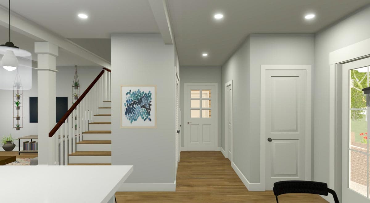 Interior view showing an entryway with a staircase, decorative art, and three doors. House plan rendering.