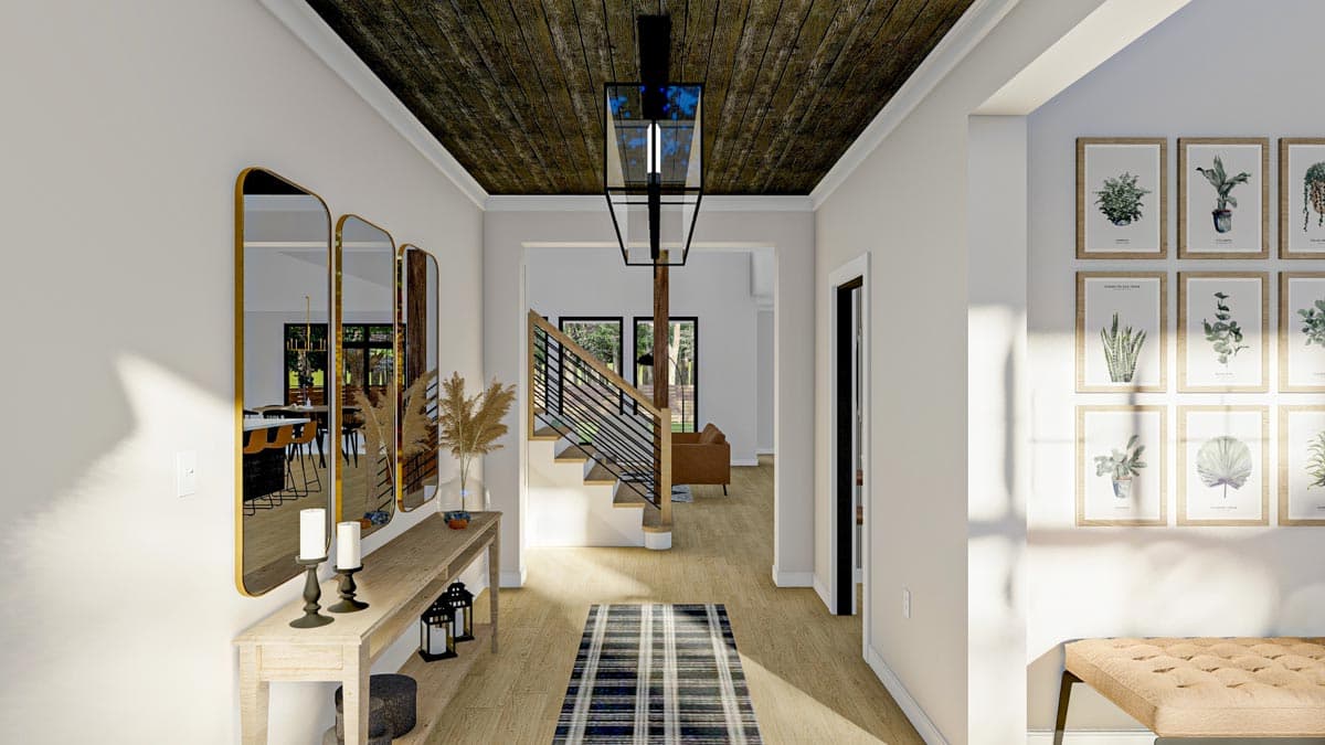 Interior view of an entryway with a plank ceiling, modern staircase with metal railing, and a gallery wall of botanical prints.