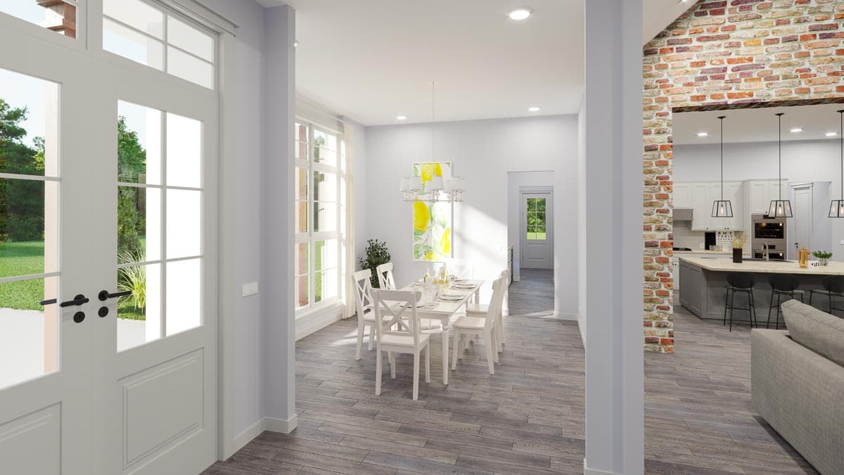 Interior rendering of a house plan showing a dining area with white table and chairs, and view to an open kitchen with island.