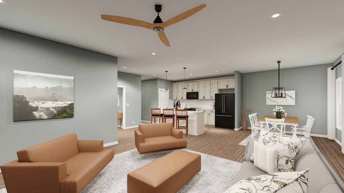 Open-concept living area with sectional sofa, kitchen island with seating, and dining area.