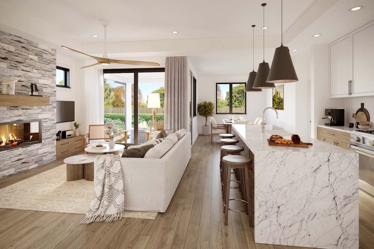 Open concept living space featuring a stone fireplace, large sofa, kitchen island with pendant lights, and dining area.