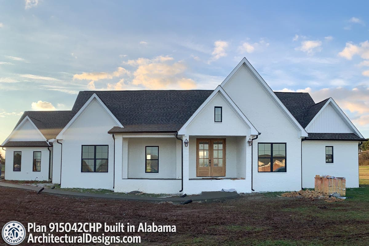 House plan exterior: Ranch-style with a covered entry porch, gables, and a brick facade.