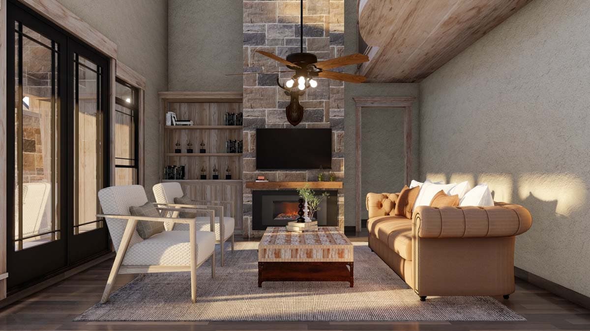Living room with stone fireplace, mounted TV, wood beams on ceiling, and French doors leading outdoors.