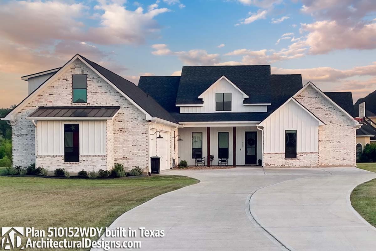 House plan exterior, Modern Farmhouse style, white brick and vertical siding, two-story with gables, covered front porch, and attached garage.