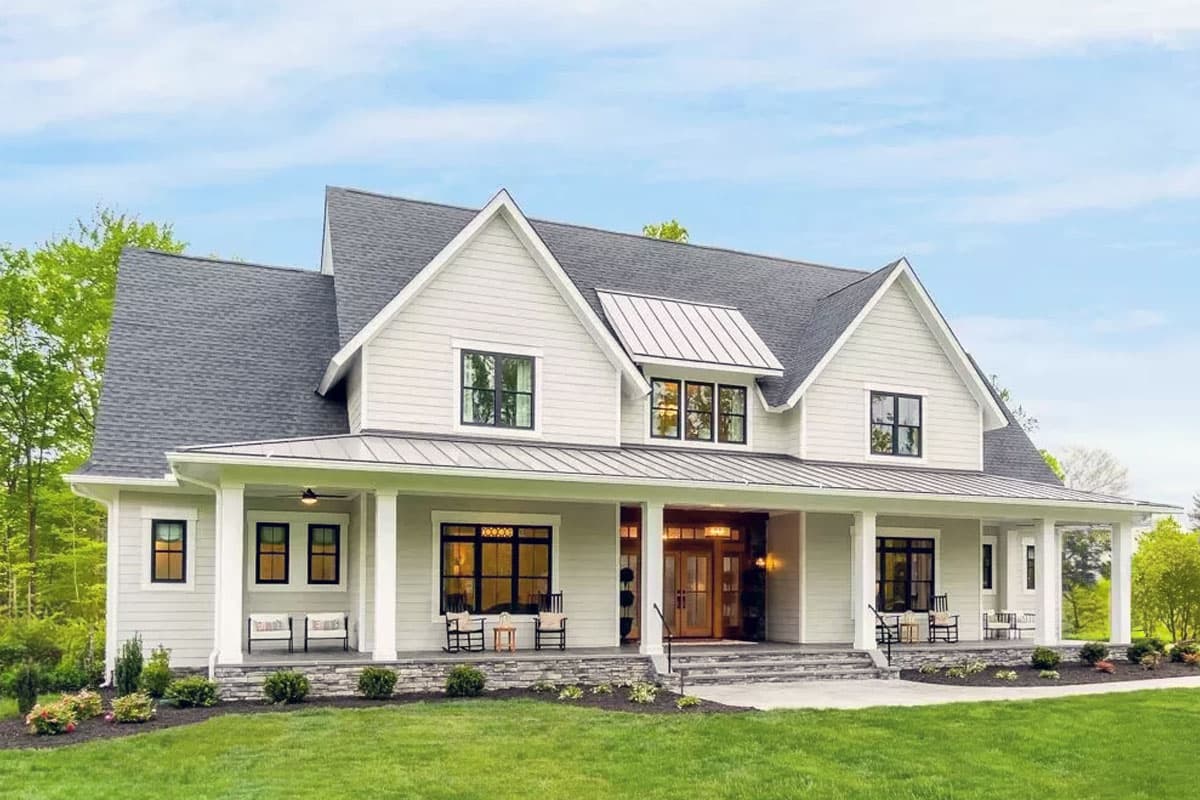 House plan exterior. Two-story Modern Farmhouse with a gabled roof, covered porch, and shed dormer above entry.