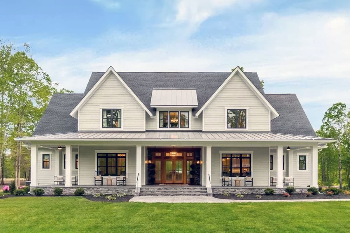 Modern Farmhouse house plan exterior with a deep wrap-around porch, gable dormers, and a metal roof accent.