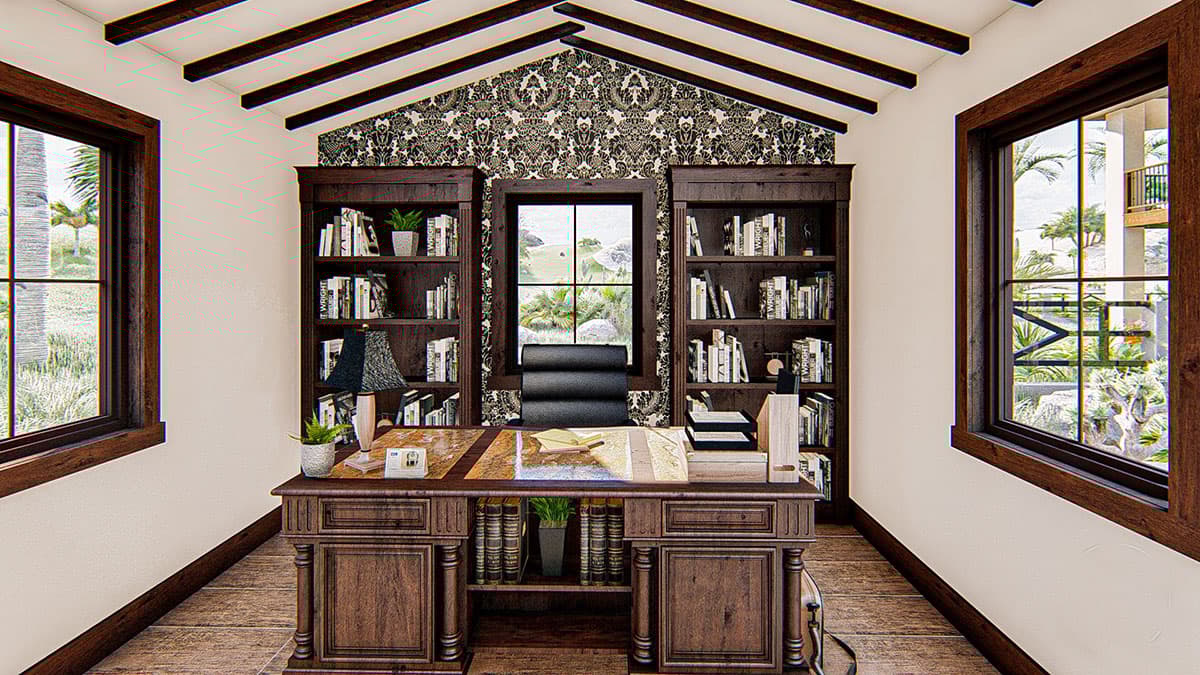 Home office interior with built-in bookshelves flanking a window, a large wooden desk, and a vaulted ceiling with exposed beams.