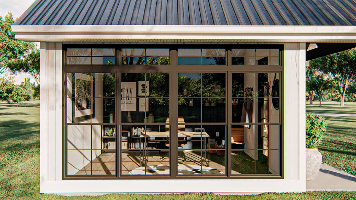 Modern farmhouse exterior with metal roof, board and batten siding, and large grid windows.