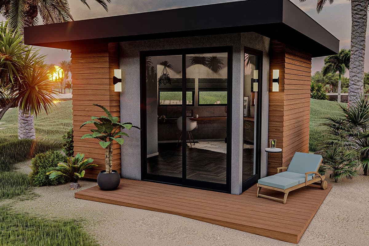 Modern micro-home exterior with wood siding, stone accents, glass doors, flat roof, and a deck.