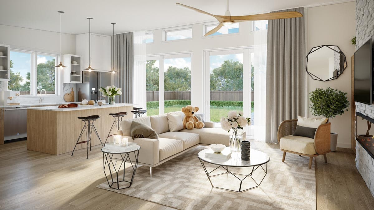 Open-concept living area with kitchen island, sectional sofa, and large windows with backyard view.