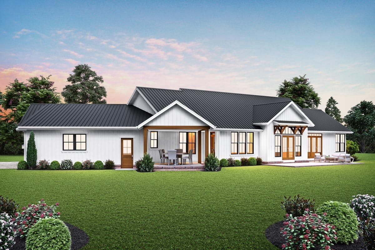 Modern Farmhouse house plan exterior with white board-and-batten siding, a black metal roof, covered porch, and multiple gables.