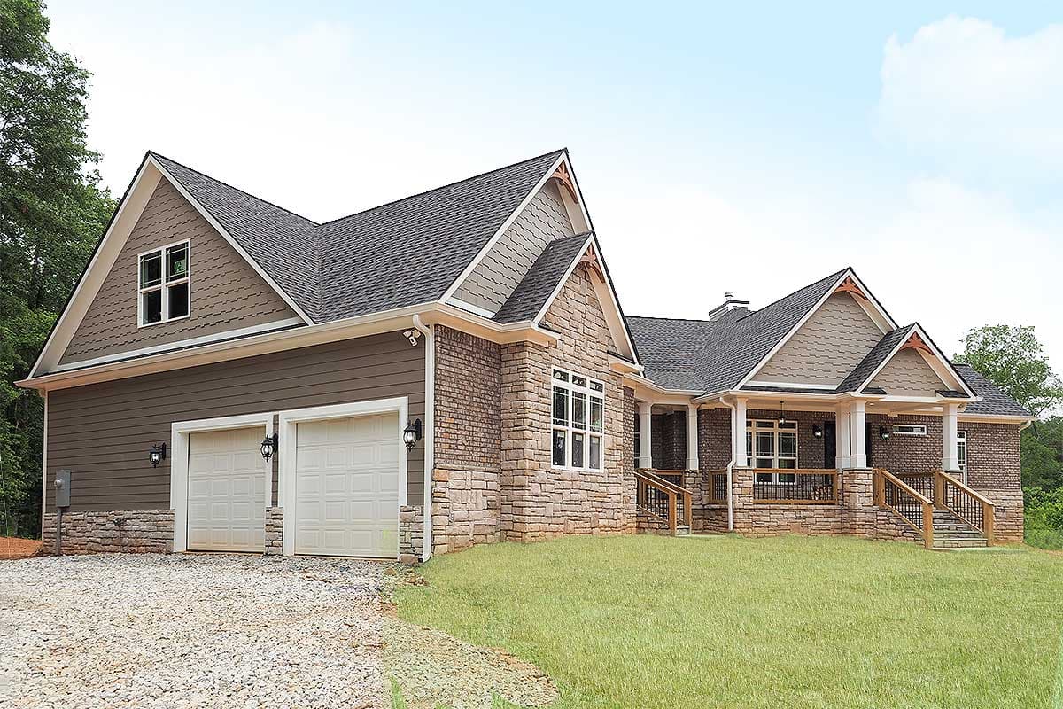 House plan exterior: Craftsman style, 1.5 stories, with a side-entry garage, stone and shingle siding, and covered front porch.