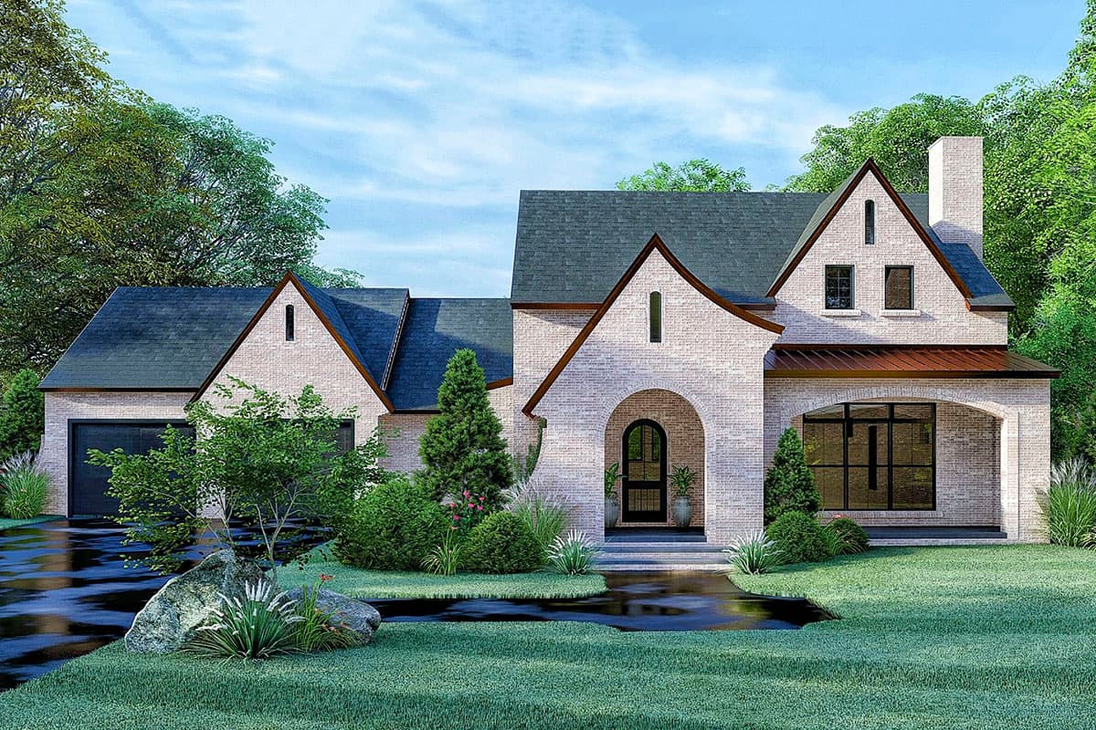 House plan exterior. Two-story brick home with arched entry, gabled rooflines, and a covered porch. Attached garage and a prominent chimney.