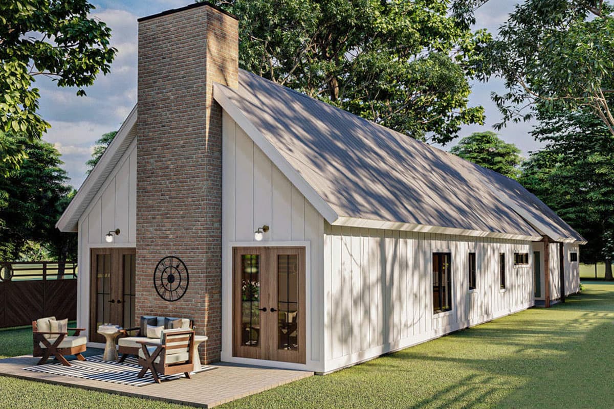 Modern Farmhouse house plan exterior with prominent brick chimney, white board-and-batten siding, and double glass doors.