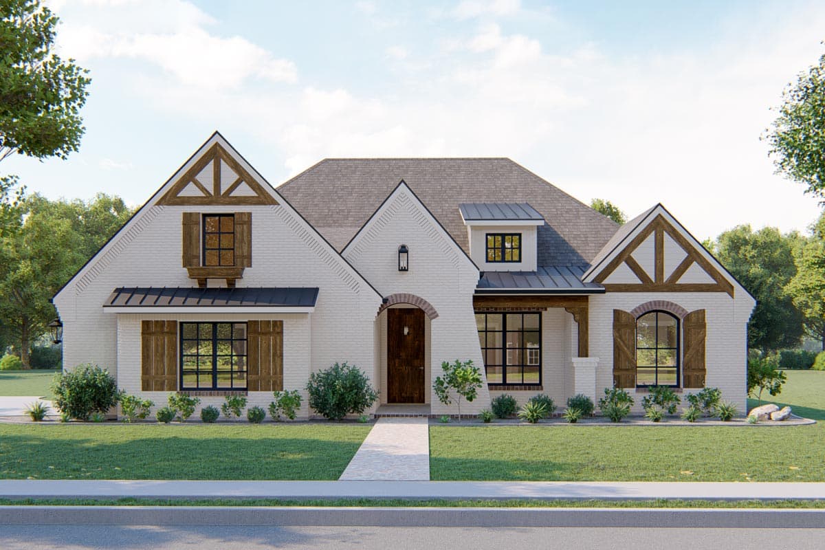 House plan exterior. Two-story home with a gabled roof, timber accents, and dormers. Features include an arched entryway and decorative shutters.
