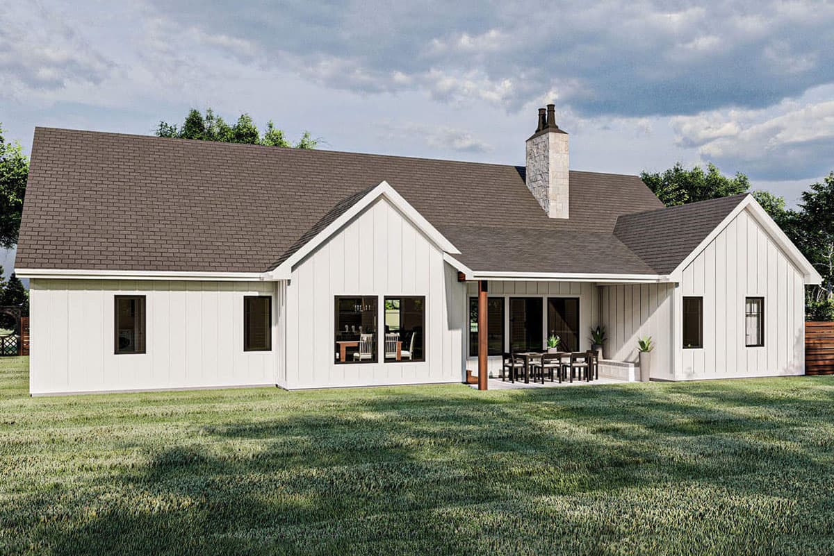 Modern Farmhouse house plan exterior with white board and batten siding, gables, covered patio, and stone chimney.