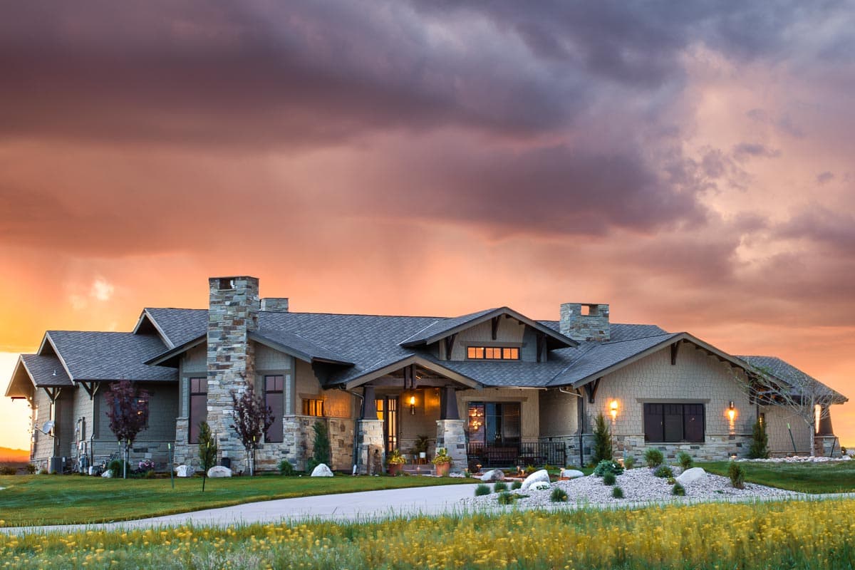 House plan exterior featuring a Craftsman style, single story, with stone accents, a covered porch, and gabled rooflines.