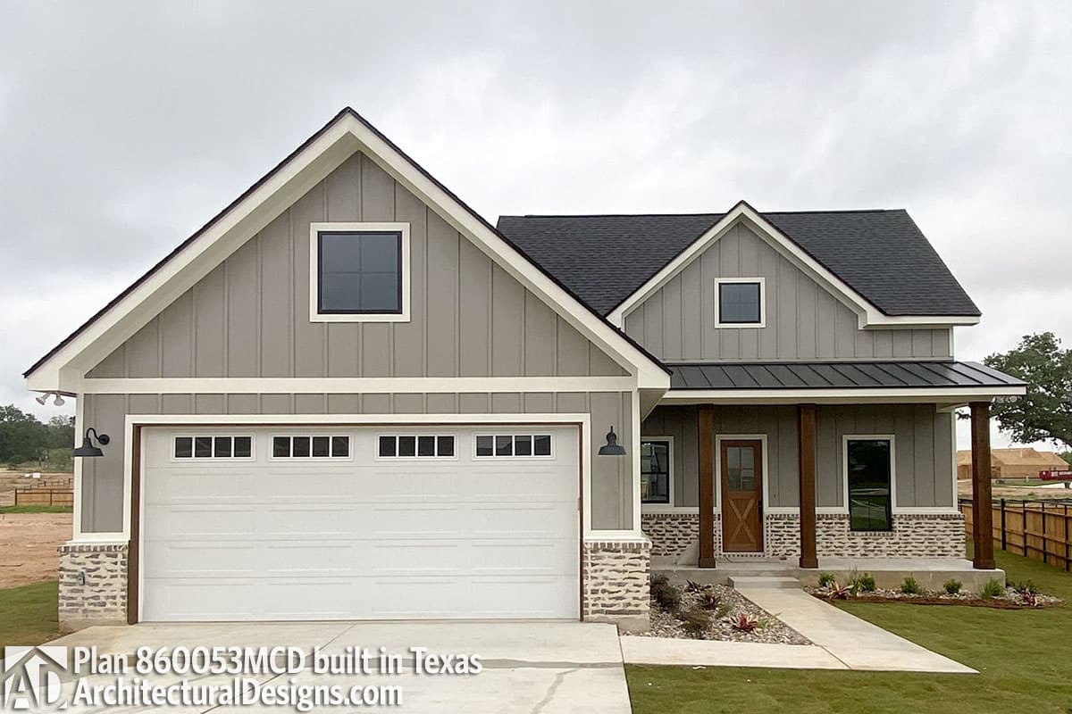 House plan exterior: Modern Farmhouse style, one-story, with a two-car garage, gables, and a covered front porch with wood columns.