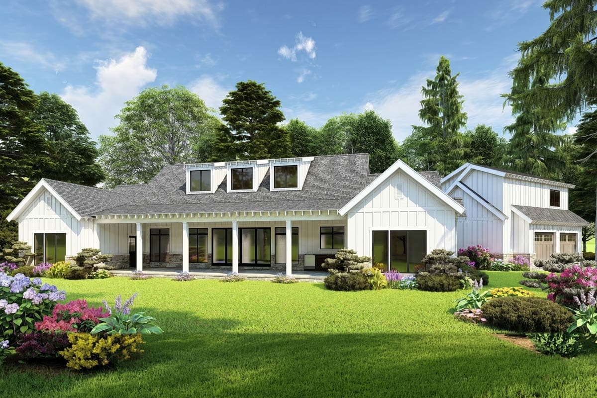 Modern Farmhouse house plan exterior with a wide covered porch, white shake siding, dormer windows, and a detached two-car garage.