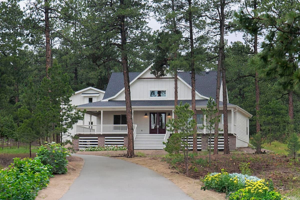 Modern Farmhouse house plan exterior with a wraparound porch, board-and-batten siding, and a prominent gable.