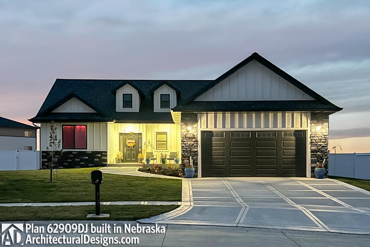 House plan exterior: Two-story Modern Farmhouse with a front-facing garage, two dormers, and a covered entry porch.